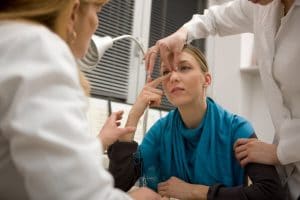 woman having nose examined