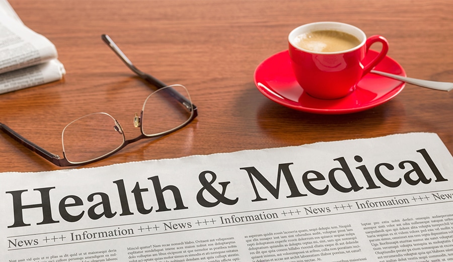 A newspaper on a wooden desk - Health and Medical