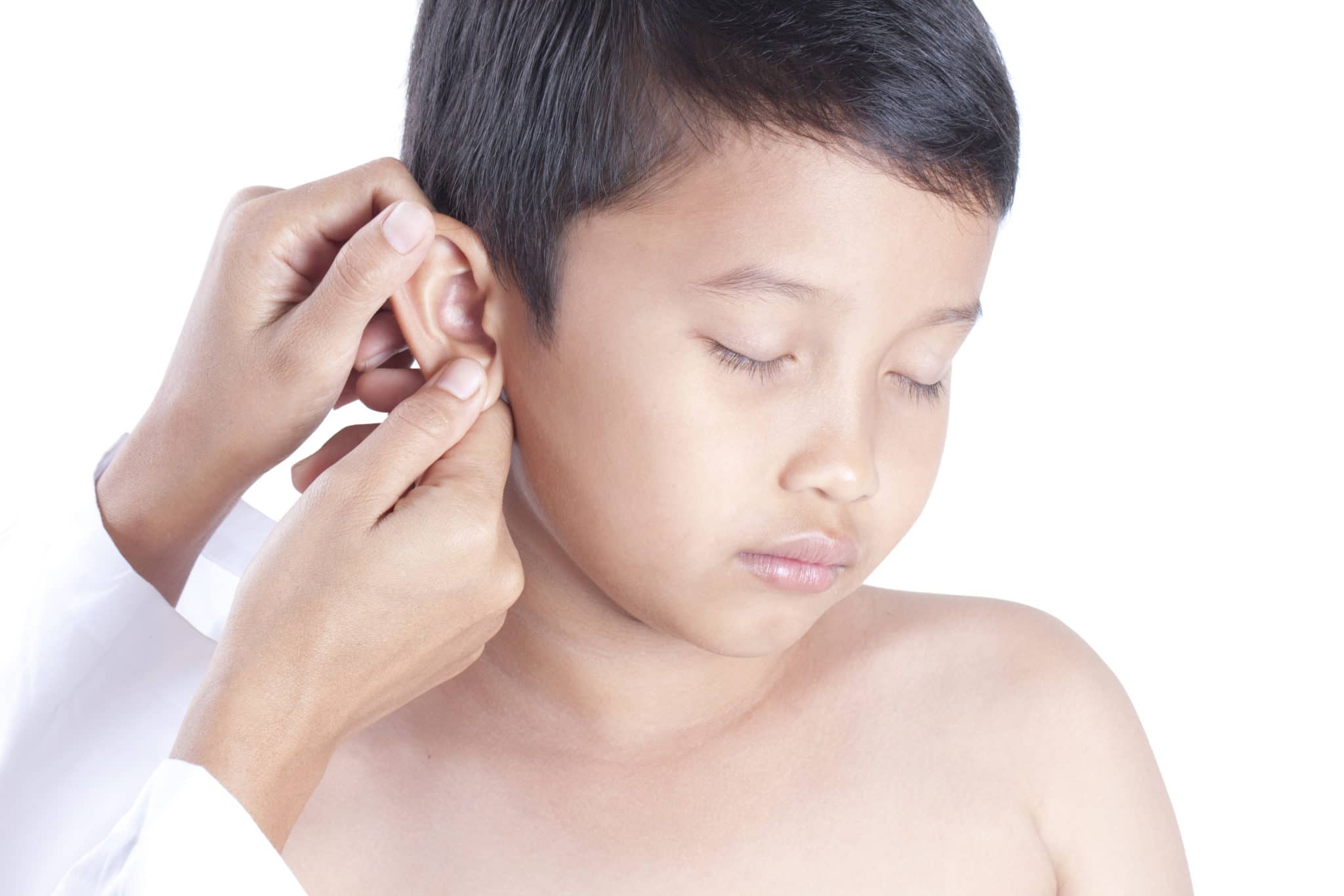 Doctor examining little boy's ears, isolated on white background