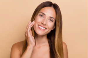 Portrait of attractive cheery long haired woman touching soft skin